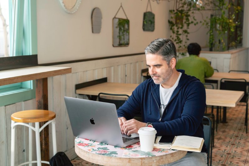 A man on a laptop is overseeing the orchestration of the customer journey